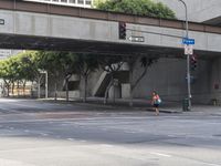 there is a street under a bridge that leads to the other side of the street