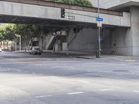 there is a street under a bridge that leads to the other side of the street