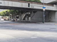 there is a street under a bridge that leads to the other side of the street