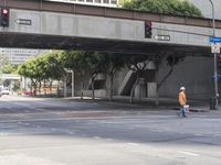 there is a street under a bridge that leads to the other side of the street