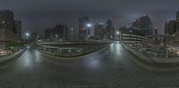 a fish eye view of the cityscape at night time and also features skyscrapers