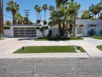 a street view of a garage and trees in the background of a white home in palm springs, florida