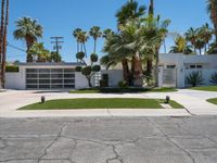 a street view of a garage and trees in the background of a white home in palm springs, florida