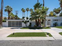 a street view of a garage and trees in the background of a white home in palm springs, florida