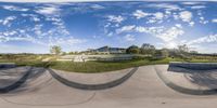 a photo from a fisheye lens is showing a person with skateboard on a ramp