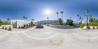 there is a fish eye lens shot of a skateboarder on the street at a skate park