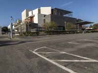 this is an empty parking lot outside a building, with no people walking on it