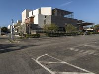 this is an empty parking lot outside a building, with no people walking on it