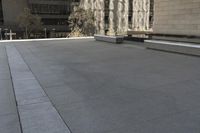 the roof of an office building shows off an outdoor area with benches and a bench,