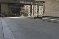 the roof of an office building shows off an outdoor area with benches and a bench,