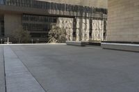 the roof of an office building shows off an outdoor area with benches and a bench,