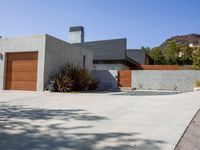 a gray concrete building with stairs and door at the top of the floor next to it is steps leading down to the doorway