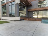 a concrete patio and modern home exterior of a modern house with nice colors and texture