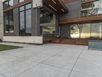 a concrete patio and modern home exterior of a modern house with nice colors and texture