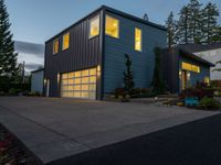 the blue house has two garages on each story and is lighted at night by led lighting