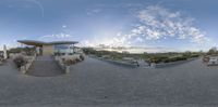 the reflection of a building on a panoramic view of an outdoor dining and patio area