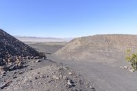 the view from top of a mountain with rocks and gravels on a clear day