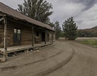 old wooden houses on a dirt road in the country side of the mountain pass area