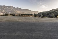 this is a nice photo of the empty lot, which leads to nowhere and mountains are visible in the distance