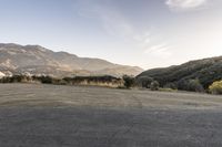 this is a nice photo of the empty lot, which leads to nowhere and mountains are visible in the distance