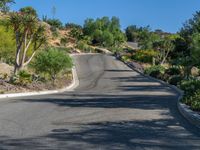 a woman is riding her motorcycle down a curved mountain road as she approaches the camera