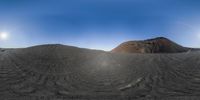 a panoramic view of a mountain covered in sand and gravel next to a truck