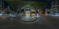 a circular view shows a very nice street with buildings and street lights on it at night