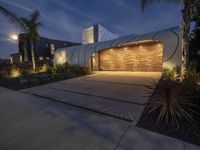 an empty garage with plants and lights on it's walls near some palm trees