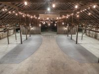 a barn with many floors and lights on the ceiling in the center of the room