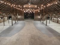 a barn with many floors and lights on the ceiling in the center of the room