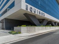 a tall building has the name equinnex on it's sides and a logo that says rquinnex