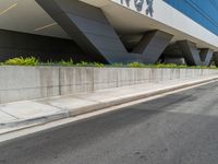 the sign is clearly visible on this building's front facade and wall as well as landscaping