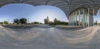 a view from above a half pipe on top of a skateboard park looking into the mirror