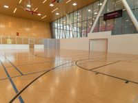 an indoor basketball court is shown here, and the lighting in this room makes it look like something inside of a house