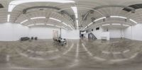 this is a fish eye view of an empty space with many tables and chairs in it