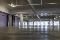 a view into a parking garage in a city, showing the inside and outside floor