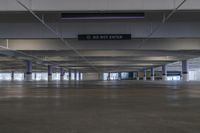 a large empty garage with lots of ceiling space and signage that says don't enter