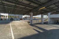 an empty parking lot is lined with parked cars and stairs leading to the garages