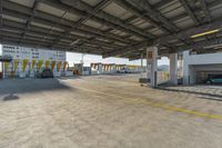 an empty parking lot is lined with parked cars and stairs leading to the garages