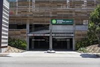 a view of a parking garage that is made out of wood planks and concrete