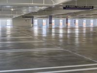 an indoor parking lot with no one on it as it does, and an empty space for vehicles