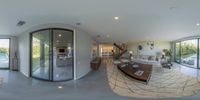 a panorama view shows the open living area and the patio outside the sliding glass door