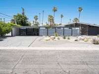 this mid century modern home features an open driveway, garages and two car garages