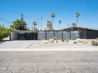 this mid century modern home features an open driveway, garages and two car garages