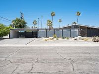 this mid century modern home features an open driveway, garages and two car garages