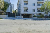 apartment building in the city with driveway to a car park on the side of the road