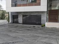 the exterior and landscape of a modern house in los angeles, california with stone and wood