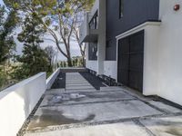 the exterior and landscape of a modern house in los angeles, california with stone and wood