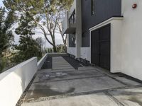 the exterior and landscape of a modern house in los angeles, california with stone and wood