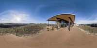 360 - view of the entrance to a winery with wine barrels and grapes in the background